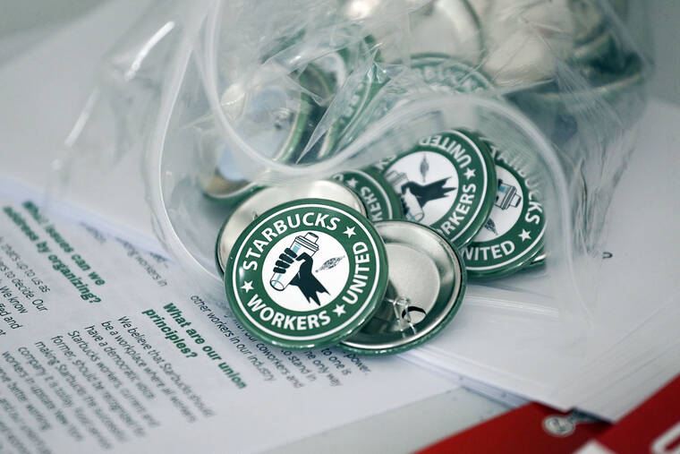 ASSOCIATED PRESS
                                Pro-union pins sit on a table during a watch party for Starbucks’ employees union election on Dec. 9 in Buffalo, N.Y.