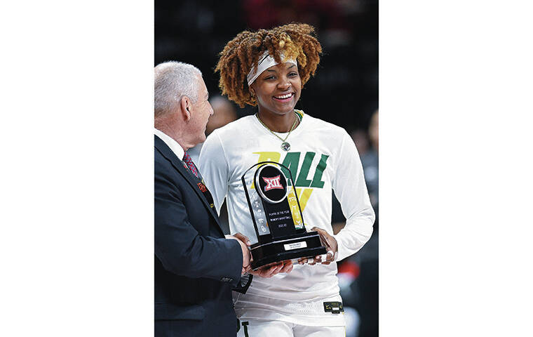 ASSOCIATED PRESS
                                Big 12 Conference Commissioner Bob Bowlsby handed Baylor’s NaLyssa Smith the Big 12 Women’s Basketball Player of the Year trophy last Friday.