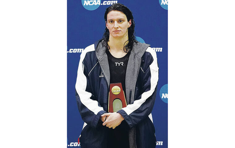 ASSOCIATED PRESS
                                Lia Thomas held her trophy after finishing tied for fifth the 200 freestyle finals.