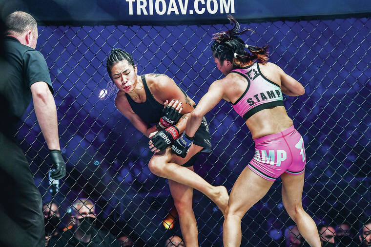 COURTESY ONE CHAMPIONSHIP
                                Stamp Fairtex, right, landed a left hook to the body that badly hurt Angela Lee in the first round of their atomweight world title fight on Saturday in Singapore.