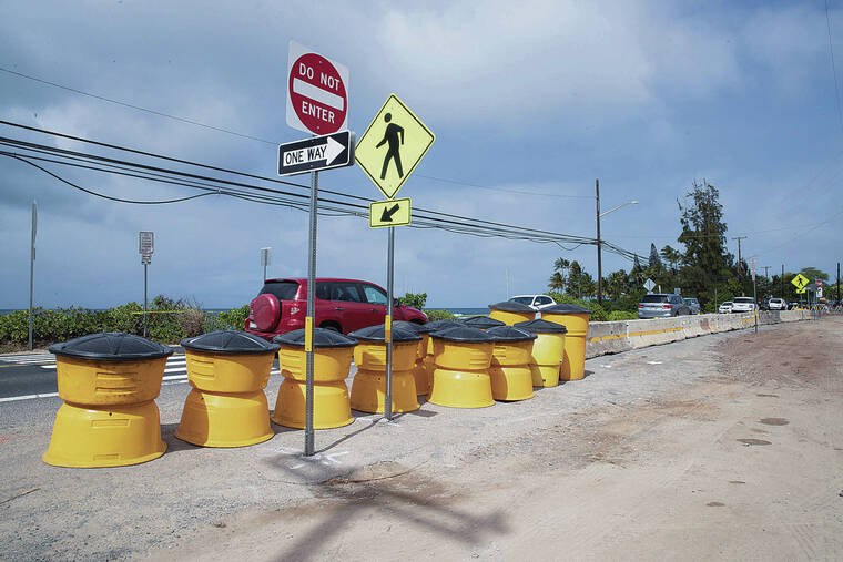 CINDY ELLEN RUSSELL / CRUSSELL@STARADVERTISER.COM / 2021
                                A spokesperson for the state Department of Transportation said Tuesday that barriers and barrels in the public parking area across from Laniakea Beach along Kamehameha Highway were scheduled to be relocated today.