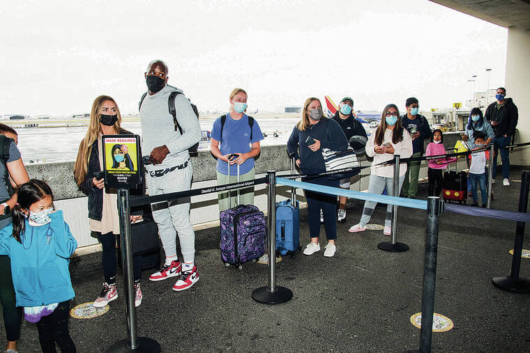 CRAIG T. KOJIMA / CKOJIMA@STARADVERTISER.COM
                                Travelers lined up Friday at the Safe Travels checkpoint at Daniel K. Inouye International Airport. The program screened more than 12 million travelers, including about 10 million visitors, in the past 17 months.