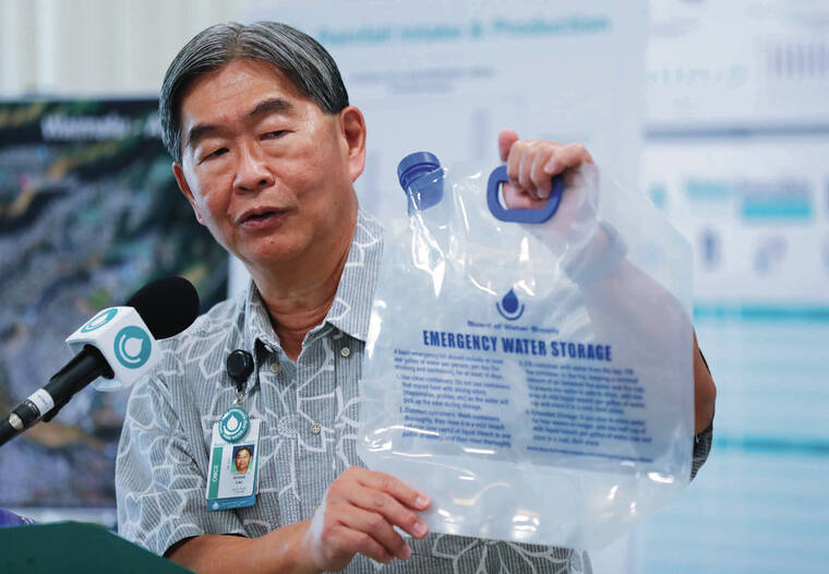JAMM AQUINO / JAQUINO@STARADVERTISER.COM
                                Board of Water Supply Manager and Chief Engineer Ernest Lau held up a portable water storage device while speaking during Thursday’s news conference.
