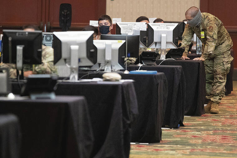 GEORGE F. LEE / 2020
                                Hawaii National Guard personnel work as COVID-19 contact tracers at the Hawai‘i Convention Center.