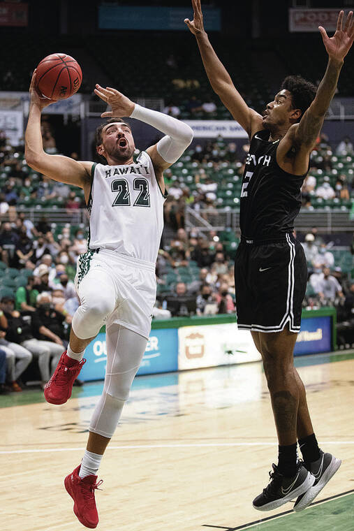 GEORGE F. LEE / FEB. 10
                                Hawaii’s Jerome Desrosiers took a shot against Long Beach State’s Jordan Roberts at SimpliFi Arena last month. The Beach defeated the Warriors, 73-66.