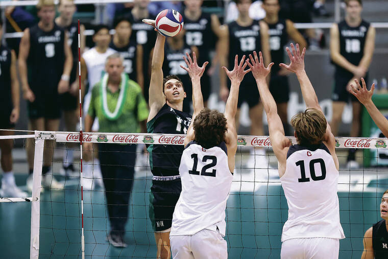 ANDREW LEE / SPECIAL TO THE STAR-ADVERTISER
                                Hawaii’s Dimitrios Mouchlias hits the ball over CSUN’s Griffin Walters (12) and Daniel Wetter (10).