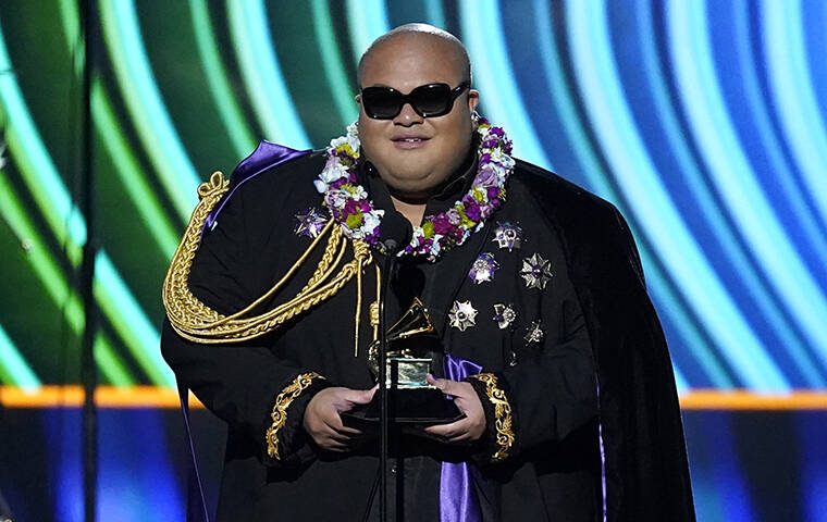 ASSOCIATED PRESS
                                Kalani Pe’a accepts the award for best regional roots musical album for “Kau Ka Pe’a” at the 64th Annual Grammy Awards today in Las Vegas.