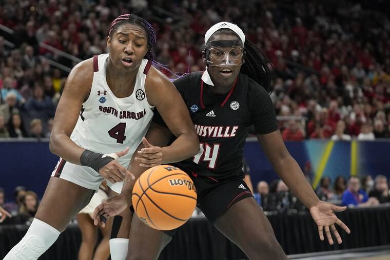 ERIC GAY / AP
                                South Carolina’s Aliyah Boston and Louisville’s Olivia Cochran go after a loose ball during the first half of a college basketball game in the semifinal round of the Women’s Final Four NCAA tournament in Minneapolis.