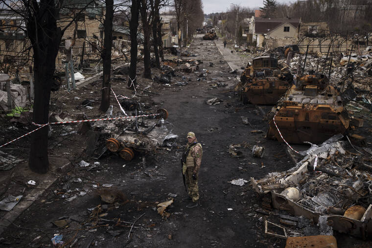 ASSOCIATED PRESS
                                A Ukrainian serviceman stood amid destroyed Russian tanks in Bucha, on the outskirts of Kyiv, Ukraine, today.