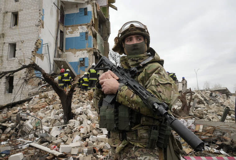 ASSOCIATED PRESS
                                A Ukrainian soldier stood against the background of an apartment house ruined in the Russian shelling in Borodyanka, Ukraine, today.