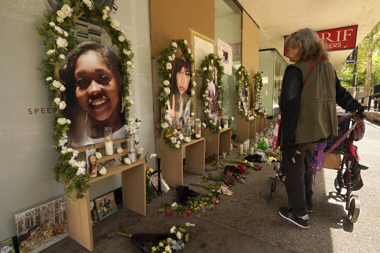 ASSOCIATED PRESS
                                A passerby pauses at a memorial for the six people killed in mass shooting in Sacramento, Calif., on Wednesday, April 6, 2022. Multiple people were killed and injured in the shooting that occurred Sunday, April, 3.
