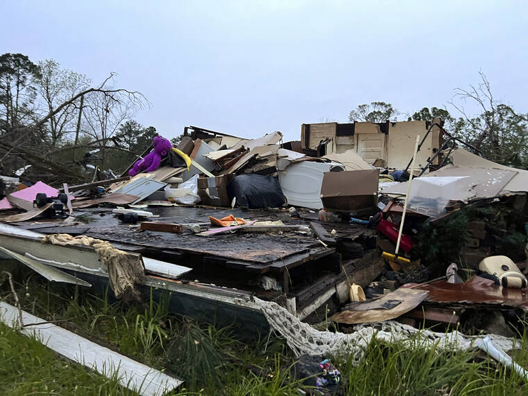 ASSOCIATED PRESS / APRIL 5
                                Damage is seen at a house on South Main Street in Pembroke, Ga., 30 miles from Savannah, after a storm passed through the city.