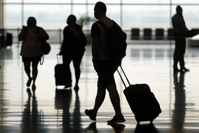 ASSOCIATED PRESS / AUG. 17
                                Travelers move through Salt Lake City International Airport in Salt Lake City. The Federal Aviation Administration said that it’s seeking record civil fines against two passengers who assaulted other people on flights last summer.