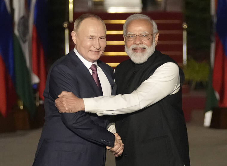 ASSOCIATED PRESS / 2021
                                Russian President Vladimir Putin, left, and Indian Prime Minister Narendra Modi greet each other before their meeting in New Delhi, India. India on Thursday said it would ramp up its production of military equipment, including helicopters, tank engines, missiles and airborne early warning systems, to offset any potential shortfall from its main supplier Russia. Former Lt. Gen. D.S. Hooda said that during a visit to India last year by Russian President Vladimir Putin the two sides decided to shift some manufacturing to India to meet its requirements.