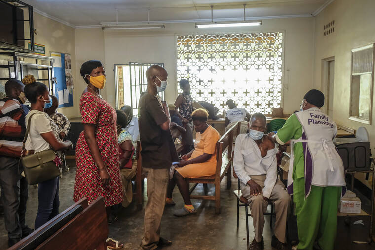 ASSOCIATED PRESS / FEB. 8
                                Ugandans receive Pfizer coronavirus vaccinations at the Kiswa Health Centre III in the Bugolobi neighborhood of Kampala, Uganda.