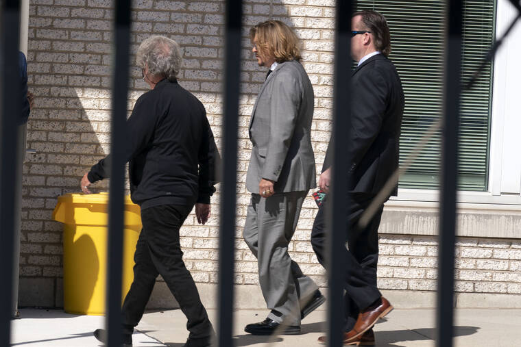 ASSOCIATED PRESS / APRIL 11
                                Actor Johnny Depp, center left, leaves the Fairfax County courthouse after a jury selection day in Fairfax Va.