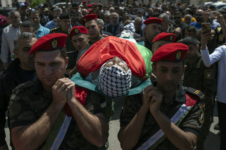 NASSER NASSER / AP
                                Palestinian security officers carry the body of Muhammad Assaf, during his funeral in the West Bank village of Kufr Laqef, near Qalqiliya.