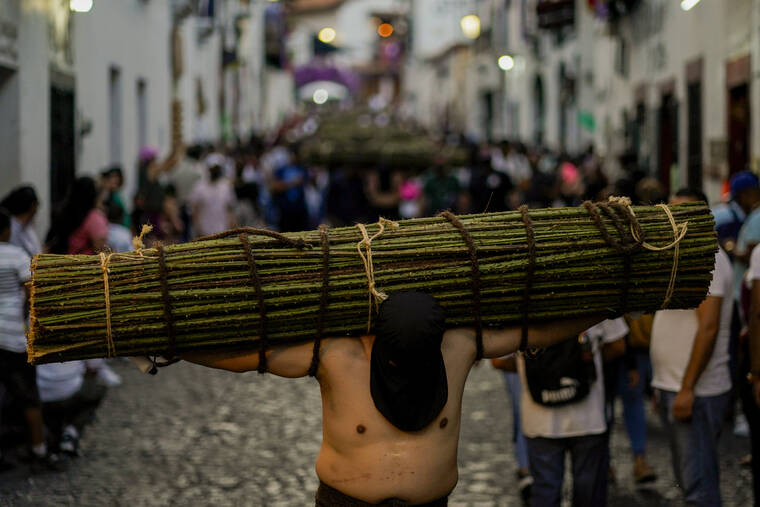 ASSOCIATED PRESS / APRIL 14
                                A penitent carries a bundle of thorny branches during a Holy Week procession in Taxco, Mexico.