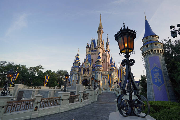 ASSOCIATED PRESS
                                The newly painted Cinderella Castle at the Magic Kingdom at Walt Disney World was seen with the the crest to celebrate the 50th anniversary of the theme park, Aug. 30, 2021, in Lake Buena Vista, Fla. Florida Gov. Ron DeSantis is asking lawmakers to end Disney’s government in a move that jeopardizes the symbiotic relationship between the state and company.