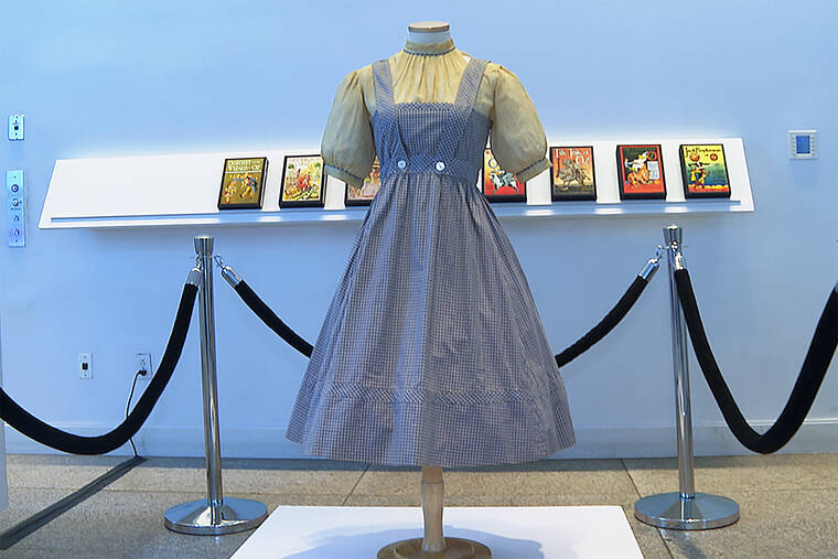 ASSOCIATED PRESS / APRIL 25
                                A blue and white checked gingham dress, worn by Judy Garland in the “Wizard of Oz,” hangs on display at Bonhams in New York. One of the most iconic outfits in American movie history is heading for auction, discovered in a box after decades of being thought lost. The dress was found last year at the Catholic University of America, and is on display in New York City before being put up for sale next month by Bonhams.