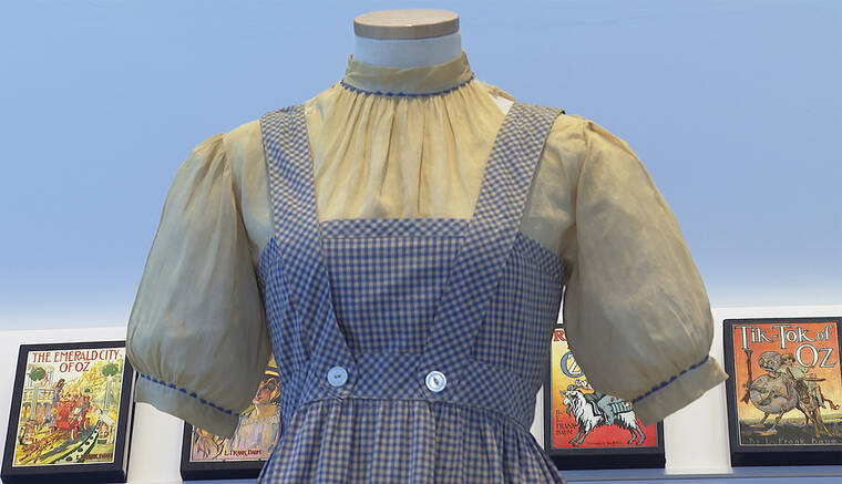 ASSOCIATED PRESS / APRIL 25
                                A blue and white checked gingham dress, worn by Judy Garland in the “Wizard of Oz,” hangs on display at Bonhams in New York. One of the most iconic outfits in American movie history is heading for auction, discovered in a box after decades of being thought lost. The dress was found last year at the Catholic University of America, and is on display in New York City before being put up for sale next month by Bonhams.