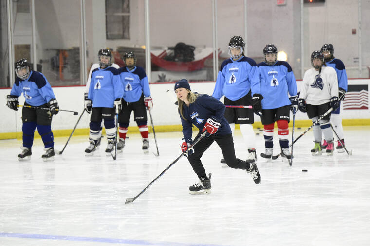 ASSOCIATED PRESS
                                U.S. hockey player Haley Skarupa, front, demonstrates a drill during a hockey clinic presented by the Washington Capitals and the Professional Women’s Hockey Players Association on March 4 in Arlington, Va.