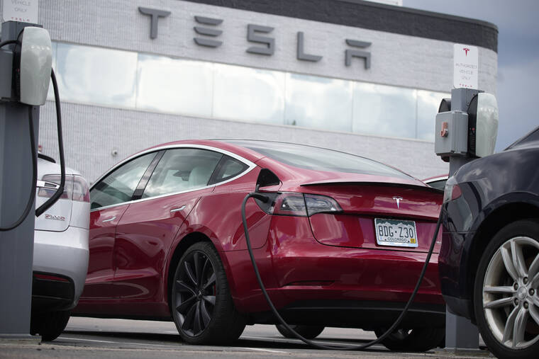 ASSOCIATED PRESS A 2021 Tesla Model 3 sedan sat in a near-empty lot at a Tesla dealership in Littleton, Colo., June 27. Tesla has recalled 14,684 Model 3s due to a software glitch that could cause collisions, its second recall this month, Chinas market regulator said Friday, April 29, 2022.