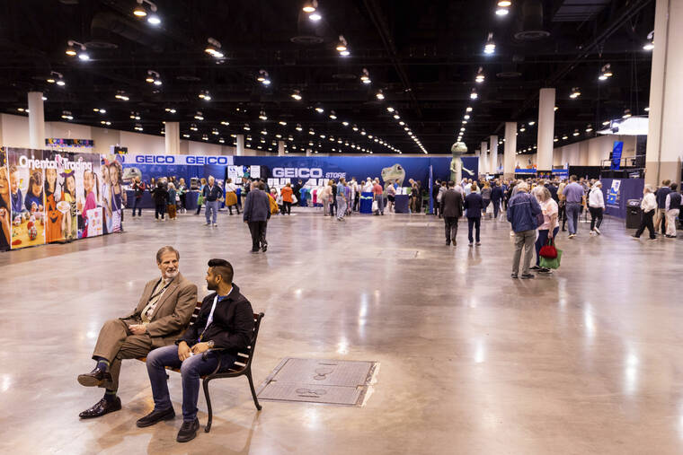 OMAHA WORLD-HERALD / ASSOCIATED PRESS / APRIL 29
Two men take a break on a bench during the Berkshire Hathaway 2022 Annual Shareholders Meeting weekend at the CHI Health Center in Omaha, Neb.