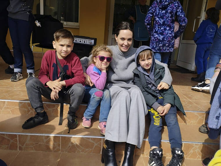 LVIV CITY HALL / AP
                                Angelina Jolie, Hollywood movie star and UNHCR goodwill ambassador, poses for a photo with kids in Lviv, Ukraine.