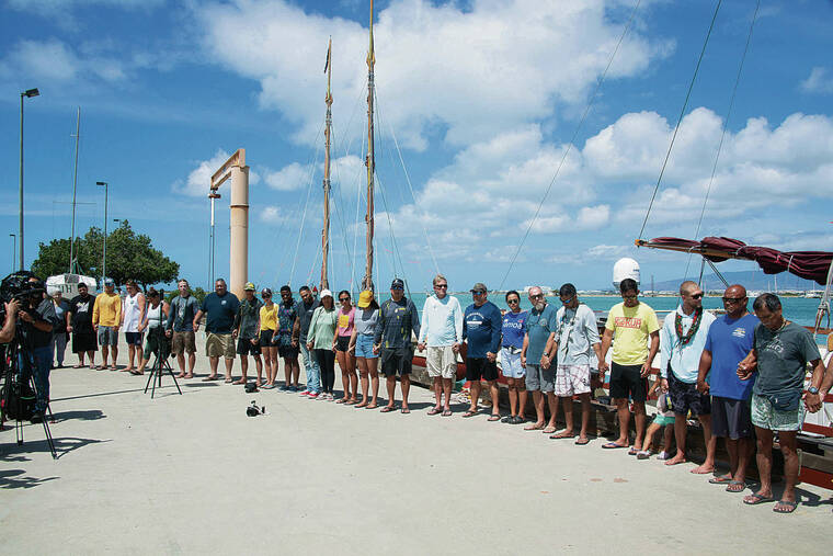 CRAIG T. KOJIMA / CKOJIMA@STARADVERTISER.COM
                                Above, crew members and family held a pule before the voyaging canoes left.