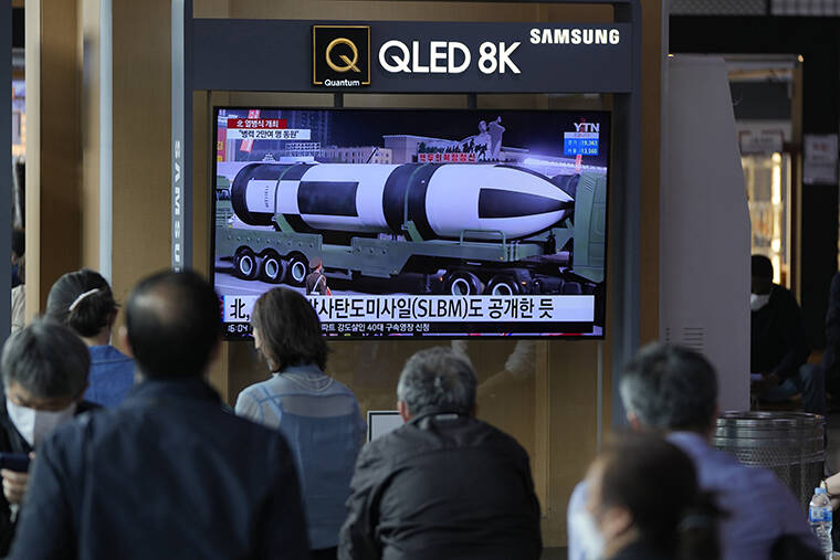 LEE JIN-MAN / AP
                                People watch a TV screen showing a news program reporting about North Korea’s military parade with an image at a train station in Seoul, South Korea.