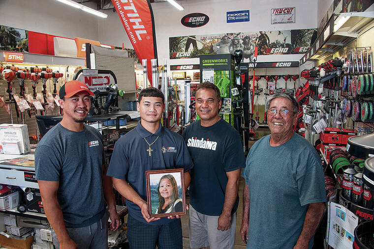 CRAIG T. KOJIMA / CKOJIMA@STARADVERTISER.COM
                                Waipahu Lawn Equipment Sales and Service Inc. is a family-run business led by Terrence Fernandez, second from right. Pictured from left is his older son Cody, younger son Chase and father-in-law Richard Miyasato. Chase is holding a picture of his mother, Richelle “Shelly” Fernandez, who died in 2015.