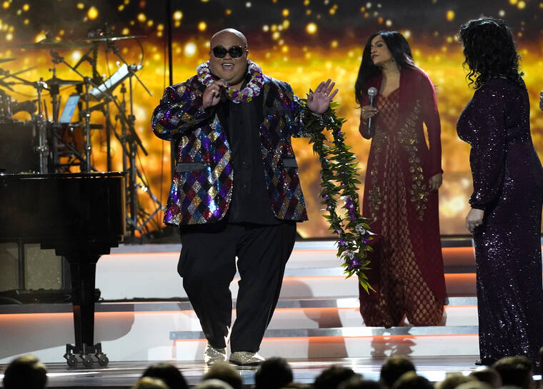 ASSOCIATED PRESS
                                Kalani Pe‘a won a Grammy Sunday for his third album, “Kau Ka Pe‘a.” Pe‘a, from left, Falu and Becky Isaacs performed Sunday at the nontelevised premiere ceremony of the 64th Annual Grammy Awards in Las Vegas.