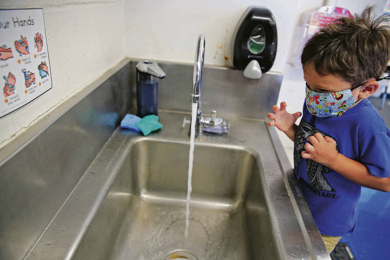 JAMM AQUINO / JAQUINO@STARADVERTISER.COM
                                Preschooler Jacob Torres, 4, got ready to wash his hands before lunch.