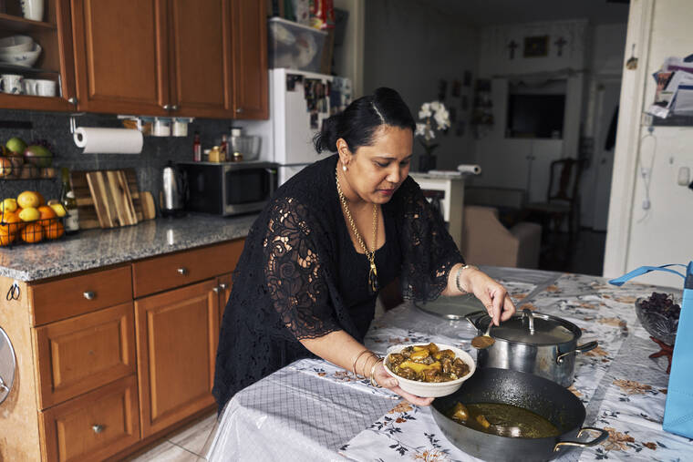 NEW YORK TIMES
                                Jullet Achan, who makes meals that customers buy through the WoodSpoon app, in her kitchen at her apartment in New York on Feb. 2. Tens of billions of dollars are being spent on what, where and how people will eat in the coming years, but laws and regulations aren’t always keeping up.