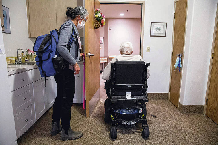 NEW YORK TIMES
                                A palliative care doctor helps a hospice patient in Corvallis, Ore.