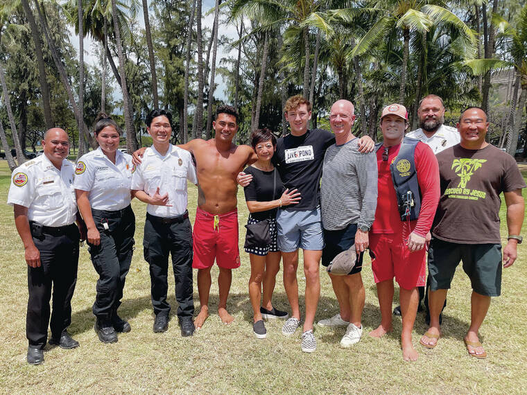 COURTESY HONOLULU EMERGENCY MEDICAL SERVICES
                                Honolulu Emergency Medical Services Assistant Chief of Operations Arnold Paragoso, left; EMS paramedics Samantha Blanchard and Jared Tanouye; Honolulu Ocean Safety lifeguard Kekoa Kekumano; Manami, Kai and David Keuning; Ocean Safety rescue operator Chris Braun; EMS Chief Chris Sloman; and Ethan Won gathered at Kaimana Beach Park on Thursday to celebrate the young surfer’s rescue and recovery after a head injury and near drowning.