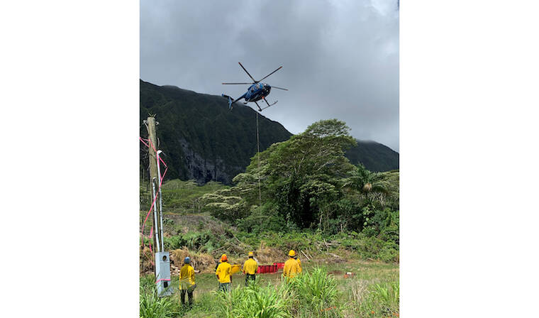 COURTESY HAWAII DEPARTMENT OF LAND AND NATURAL RESOURCES
                                A helicopter picks up citric acid solution via “bambi buckets” for an aerial drop in an effort to eliminate coqui frogs in Waimanalo.