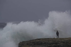 CINDY ELLEN RUSSELL / JULY 25
                                Waves generated by Hurricane Douglas crashed on the edge of Laie Point as a spectator got a closer look.