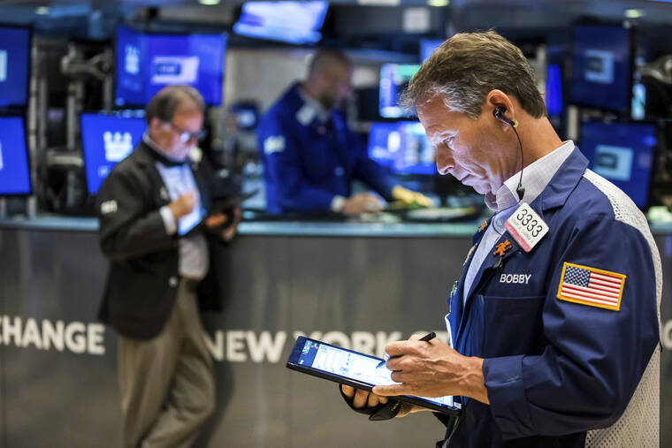 COURTNEY CROW/NEW YORK STOCK EXCHANGE VIA AP
                                Trader Robert Charmak, right, works on the floor. The subdued start to May follows a dismal April, where Big Tech companies dragged the broader market lower as they started to look overpriced, particularly with interest rates set to rise sharply.
