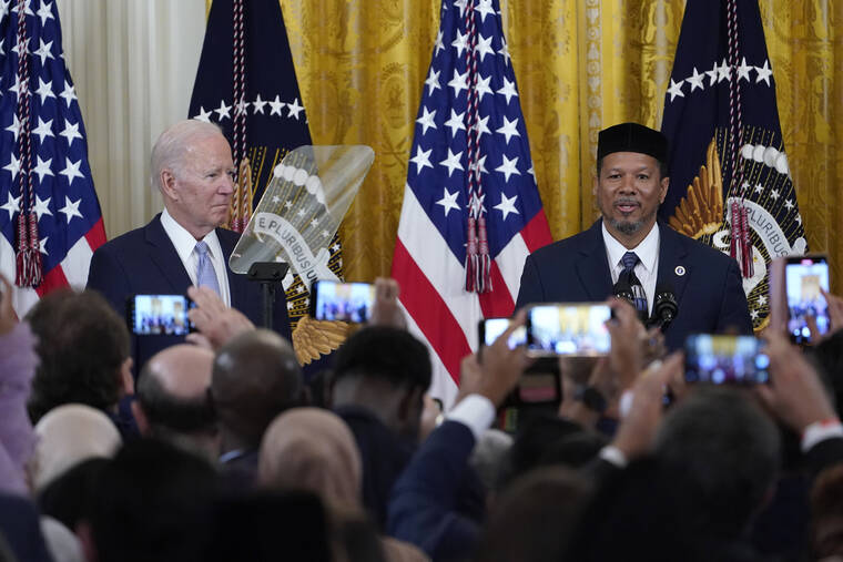 ASSOCIATED PRESS
                                President Joe Biden, left, listens as Talib M. Shareef, right, President and Imam of the historic, Nation’s Mosque, Masjid Muhammad in Washington, speaks during a reception to celebrate Eid al-Fitr in the East Room of the White House in Washington.