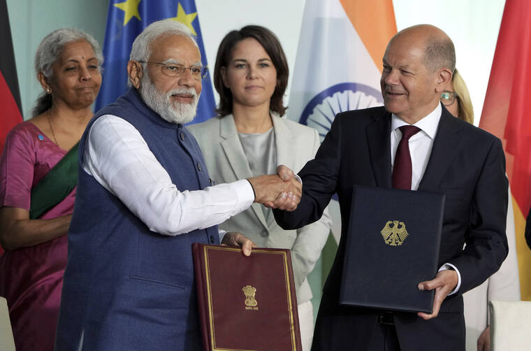 ASSOCIATED PRESS
                                German Chancellor Olaf Scholz, right, and Indian Prime Minister Narendra Modi, left, shake hands after the contract signing ceremony as part of a meeting at the chancellery in Berlin, Germany.