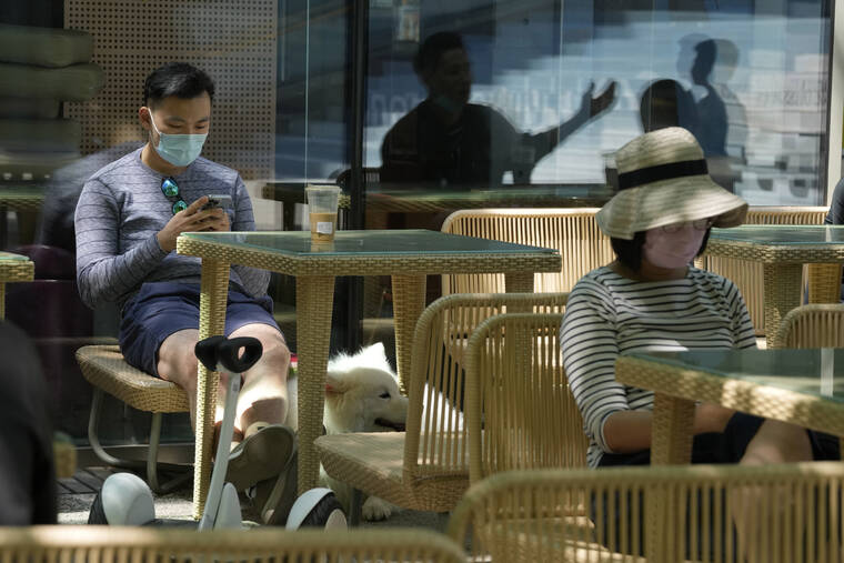 ASSOCIATED PRESS
                                Visitors to a mall rest near outdoor tables at a mall area in Beijing. Many Chinese marked a quiet May Day this year as the government’s “zero-COVID” approach restricts travel and enforces lockdowns in multiple cities.