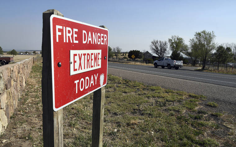 THOMAS PEIPERT / AP
                                A fire warning sign is pictured in Las Vegas, N.M.