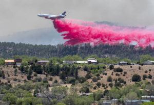 THE ALBUQUERQUE JOURNAL / AP / MAY 3
                                A slurry bomber dumps the fire retardant between the Calf Canyon/Hermit Peak Fire and homes on the westside of Las Vegas, N.M.