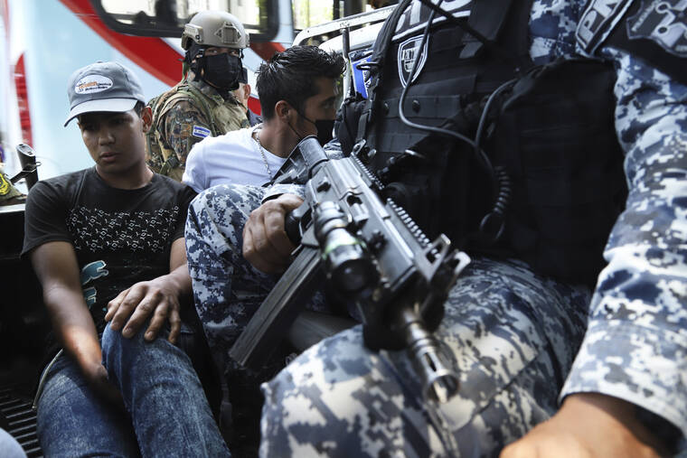 ASSOCIATED PRESS
                                Men are detained by the police near a market in San Salvador, El Salvador, on March 27.