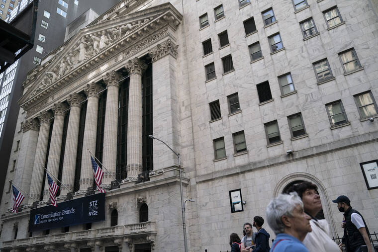 ASSOCIATED PRESS
                                Pedestrians passed the New York Stock Exchange, Thursday, in the Manhattan borough of New York. A turbulent week on Wall Street ended today with more losses and the stock market’s fifth straight weekly decline.