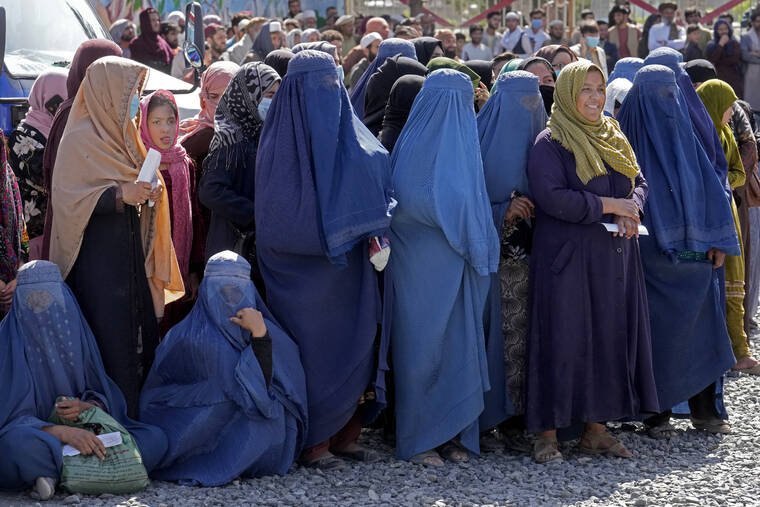 ASSOCIATED PRESS / APRIL 25
                                Afghan women wait to receive food rations distributed by a Saudi humanitarian aid group, in Kabul, Afghanistan.