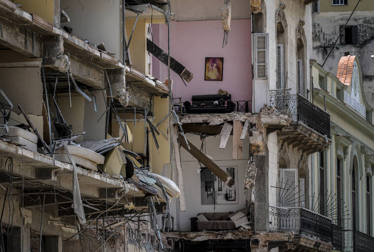 ASSOCIATED PRESS
                                Furniture, a stuffed toy and portraits adorn the walls of a home destroyed by a deadly explosion at the nearby five-star Hotel Saratoga, in Old Havana, Cuba.