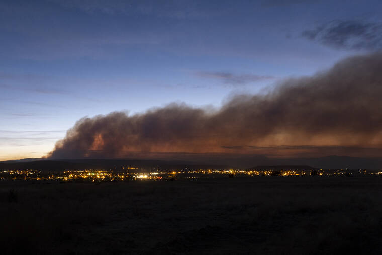 THE ALBUQUERQUE JOURNAL /AP / MAY 7
                                Smoke from the Calf Canyon/Hermits Peak Fire drifts over Las Vegas, N.M.